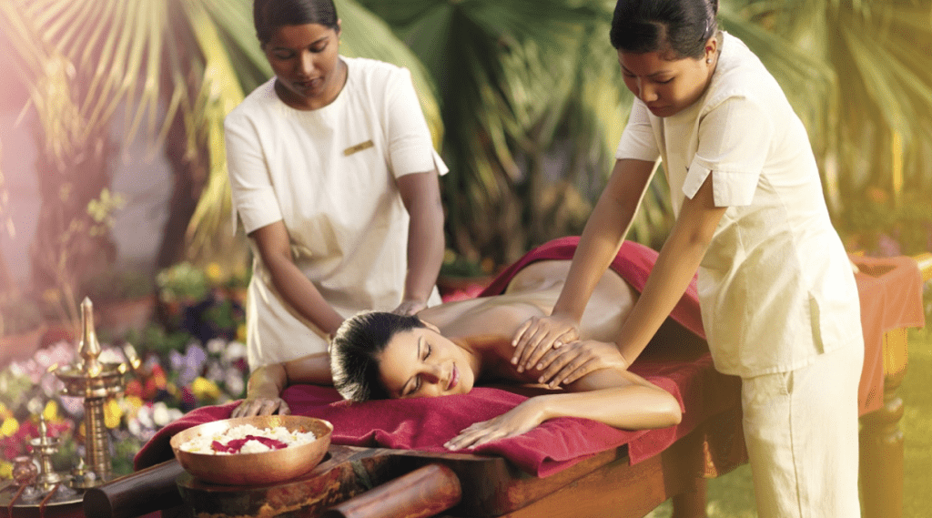 A woman enjoying a relaxing massage at a spa, surrounded by soothing ambiance and skilled therapists in Kerala.