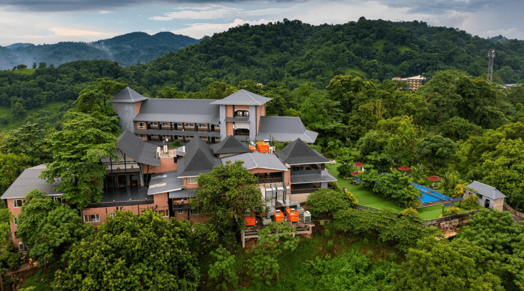 A serene resort nestled amidst verdant trees, offering a tranquil escape in nature's embrace.