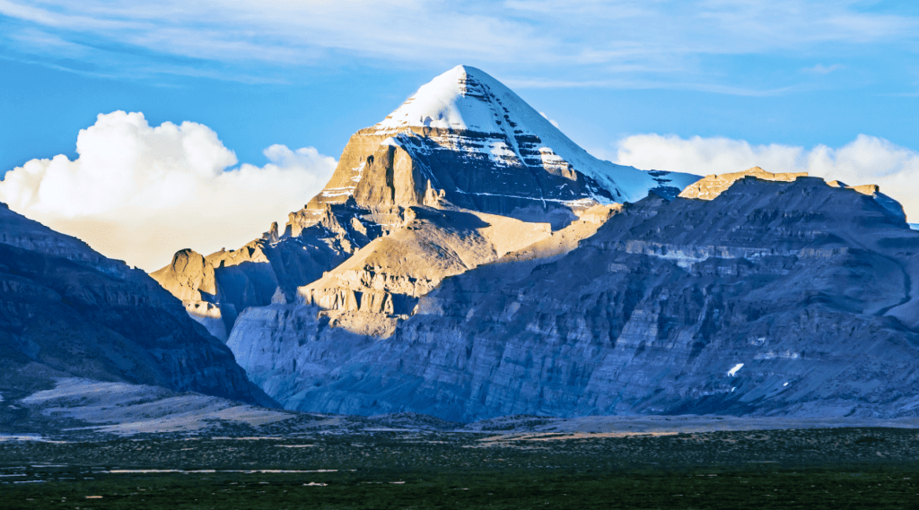 A majestic mountain with a towering peak in the distance, showcasing the grandeur of nature's beauty.