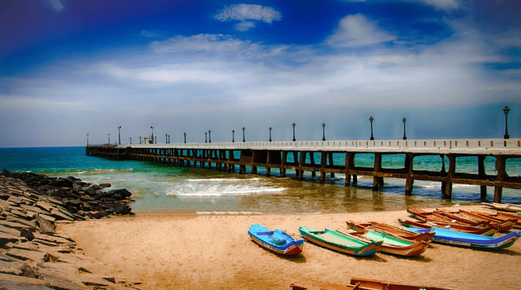 A pier with boats docked on it, surrounded by calm waters and a picturesque view. of Pondicherry
