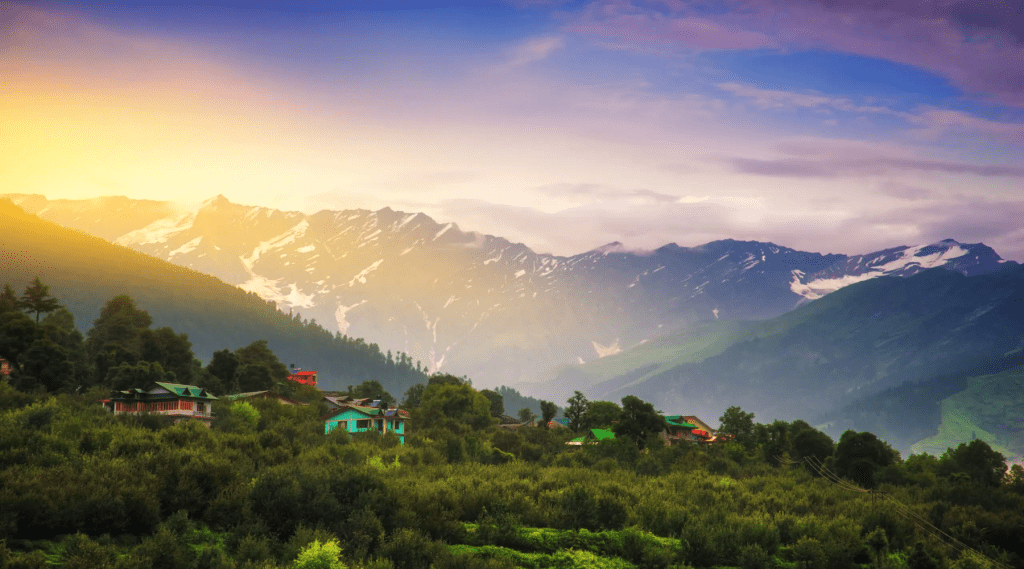 A scenic mountain landscape with charming houses and lush trees.