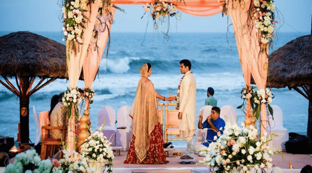 A beach wedding ceremony adorned with flowers and decorations.