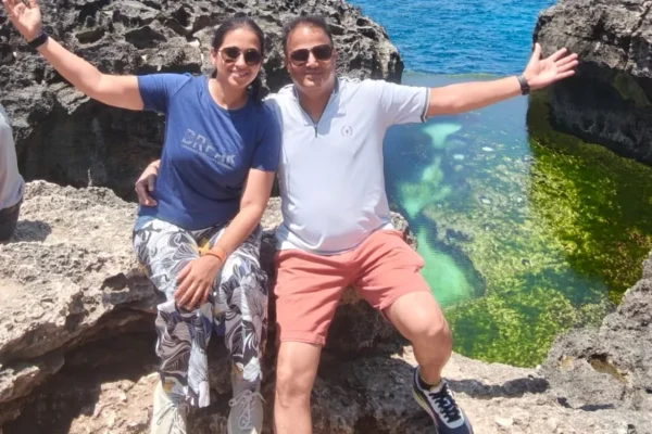 Couple with raised arms, the Angel’s Billabong pool on the right