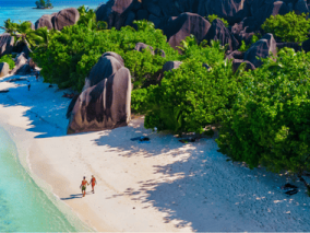 Aerial view of a Seychelles island showcasing sandy beaches and rocky formations surrounded by turquoise waters.