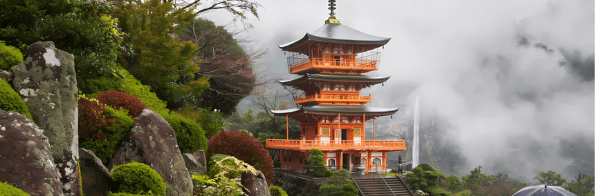 A serene pagoda atop a hill overlooks a cascading waterfall, surrounded by lush greenery.