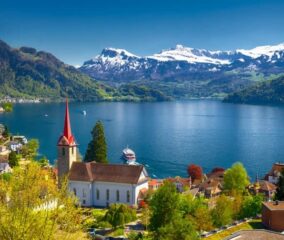 Scenic view of Lucerne, Switzerland, showcasing its charming architecture and stunning lake surrounded by mountains.